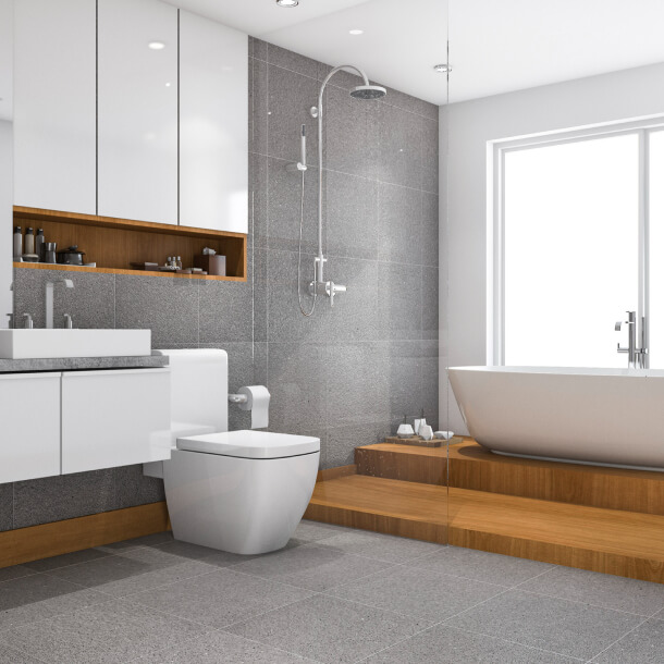 Bright bathroom with a freestanding tub, vanity and coordinated gray finishes